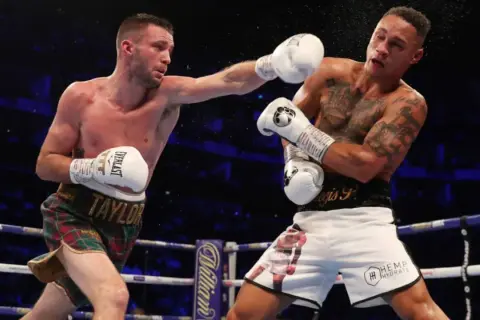 Boxer lands a punch, showcasing the intensity of a middleweight weight limit bout.