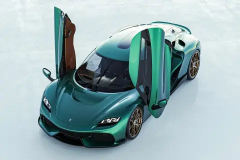 En grön Koenigsegg bil med dörrarna uppåt, redo för en tur.