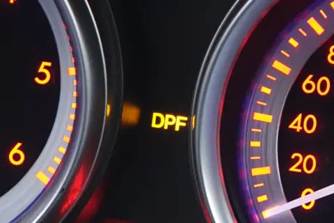 Żółta kontrolka DPF świeci się na desce rozdzielczej, sygnalizując problem z filtrem cząstek stałych.