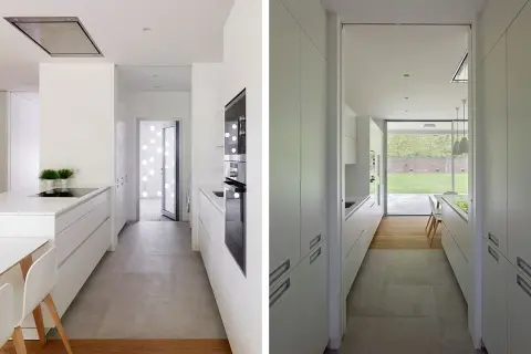 Cocina alargada blanca con encimeras y armarios modernos. Ideas para distribuir una cocina alargada de forma funcional y estilosa.
