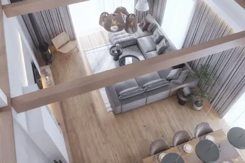 Nowoczesny salon z szarą sofą, drewnianymi belkami i jadalnią, widok z góry.