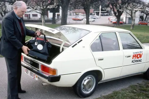 Äldre man lastar bagage i en vit Hyundai Pony. Bilen har texten "Teknikens Värld Provkörning" på sidan.