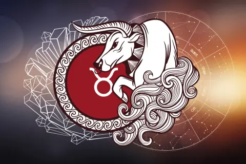 Byk, symbol zodiaku majowy, w otoczeniu kryształów i koła z gwiazdozbiorami.
