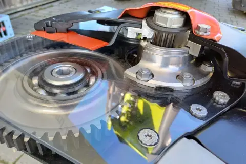 Widok mechanizmu napędowego listwy tnącej do kosiarki listwowej z widocznym łożyskiem i zębatką.