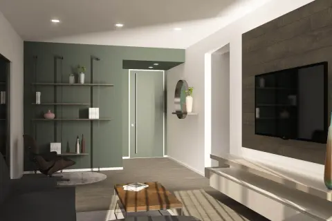 Un soggiorno moderno con parete verde, ideale per chi vuole imparare come tinteggiare una parete. Arredamento minimalista con TV a parete e poltrona di design.