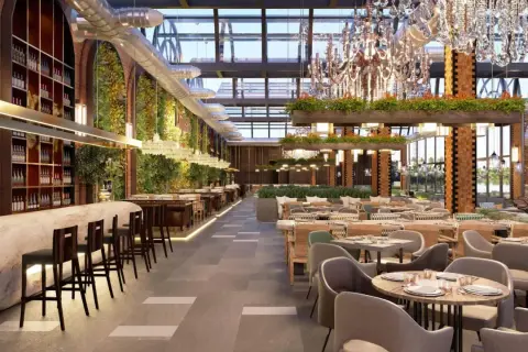 Interior de restaurante moderno con barra, mesas y vegetación. Un lugar así podría costar mucho, pero ¿cuanto cuesta abrir un restaurante?