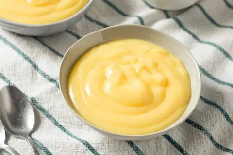 Crème anglaise on a striped cloth, a comforting dessert like crème anglaise recette grand-mère.