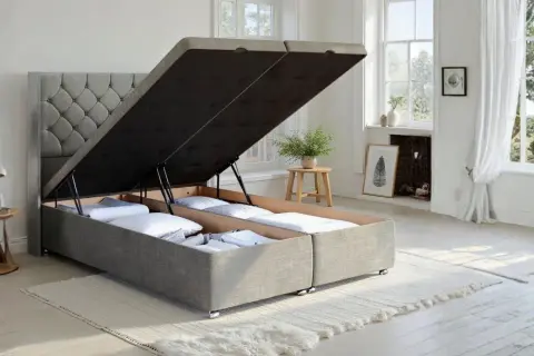 A divan bed with its storage compartments open, revealing neatly folded linens. This versatile divan offers ample hidden storage.