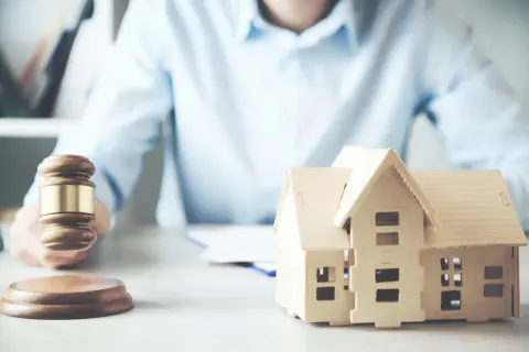 Martelletto da giudice e modello di casa, suggeriscono un possibile pignoramento immobiliare fac simile.