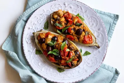 Melanzane bianche ripiene, un'idea gustosa per le tue ricette. Pomodorini, olive e basilico completano questo piatto.