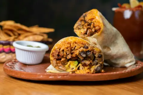 Pyszny burrito z kurczakiem, ryżem i fasolą, podane z salsą i chipsami. Idealne na szybki lunch.
