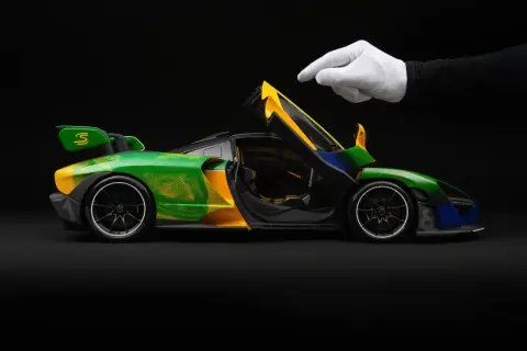 Model McLaren Senna w barwach Brazylii, z otwartymi drzwiami, gotowy do startu.