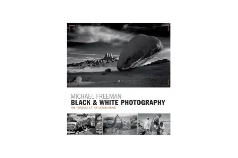 Michael Freeman's "Black & White Photography" showcases the timeless art of monochrome. This cover features a dramatic desert landscape and smaller images of buses, giraffes, and people.