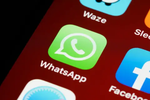 Ikona WhatsApp na ekranie telefonu. Możesz wysłać ankietę WhatsApp, aby zebrać opinie.