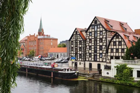 Bydgoszcz: nad Brdą, obok zabytkowych kamienic i ceglanego kościoła, cumuje barka. Nietypowe atrakcje Bydgoszcz czekają!