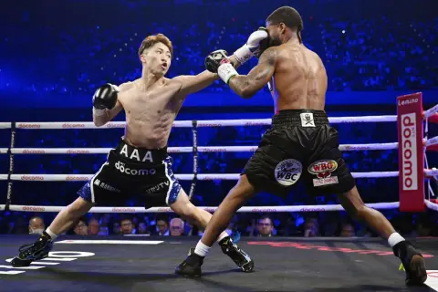Two boxers clash in a packed arena. The frequency of how often boxers fight varies greatly depending on their level and schedule.