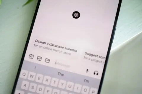 Ekran smartfona z interfejsem czatu AI, klawiaturą i ikoną ChatGPT.