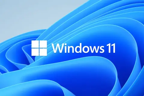 Logo Windows 11 na tle falujących, niebieskich kształtów. Czekasz na aktualizacje Windows 11?