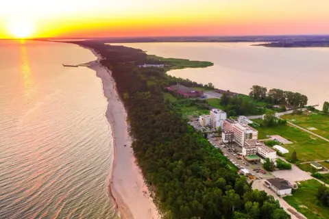 Zachód słońca nad morzem, plaża i hotele w Mielnie. Warto sprawdzić blue marine mielno opinie przed wyjazdem.