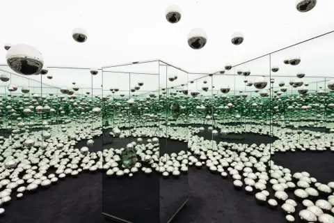 An infinity room filled with mirrored spheres, creating a dazzling, endless reflection at the Rubell Museum Miami.