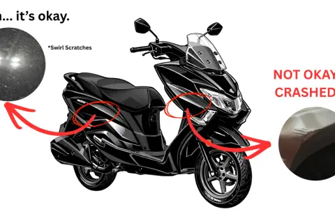 Czarny skuter z widocznymi uszkodzeniami. Sprawdzenie motocykla przed kupnem ujawnia drobne rysy i poważne pęknięcia po upadku.