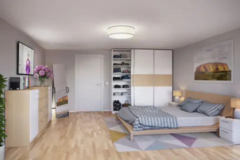 Ein gemütliches wohn- und schlafzimmer in einem kleinen raum mit Bett, Kleiderschrank, Kommode, Spiegel und TV.