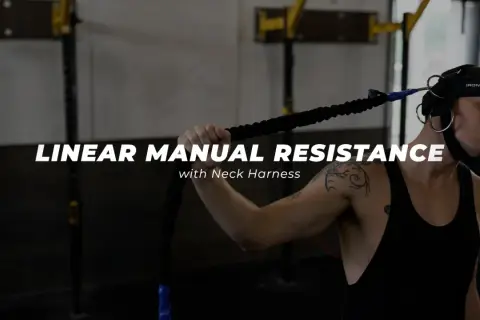 Man using a neck harness for linear manual resistance training, working neck muscles.