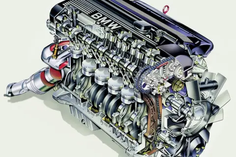 Przekrój silnika BMW M52 z widocznymi tłokami, wałkami rozrządu i turbosprężarką.