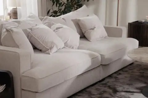 En ljus, fluffig soffa med många kuddar. Perfekt för att mysa i efter att du valt att impregnera soffan för extra skydd.