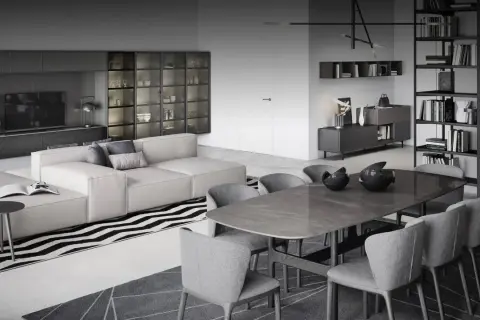 Stilvoller Wohn- und Essbereich mit moderner Trennung: Ein beiges Sofa und ein Esstisch mit grauen Stühlen schaffen eine elegante Atmosphäre.
