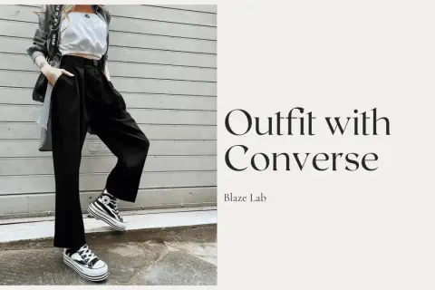 Outfit con Converse alte a righe, pantaloni neri ampi e top bianco. Ecco come allacciare le Converse alte per un look audace.