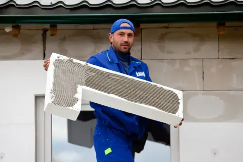 Budowlaniec z zaprawą na styropianie, który będzie montowany w murze i na zewnątrz.