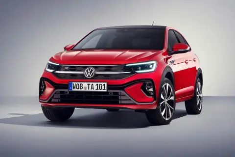 Czerwony Volkswagen Taigo z czarnym dachem prezentuje się dynamicznie. Eleganckie linie i nowoczesne światła podkreślają jego sportowy charakter.