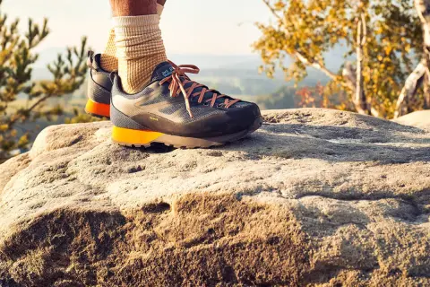 Idealne buty w Bieszczady? Te trekkingowe z pomarańczowymi akcentami zapewnią komfort na skalistym szlaku.
