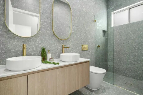 Modernos baños bonitos con lavabos sobre encimera, grifería dorada y azulejos de terrazo gris.