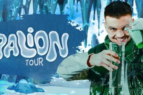 Młody mężczyzna w okularach ochronnych przelewa zielony płyn do wysokiej probówki. Obok napis "PALION TOUR" na tle lodowych sopli.