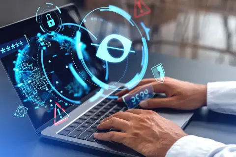Ochrona danych wrażliwych: laptop z ikonami blokady, oka i ostrzeżeń. Ręce wpisują hasło, symbolizując bezpieczeństwo cyfrowe.