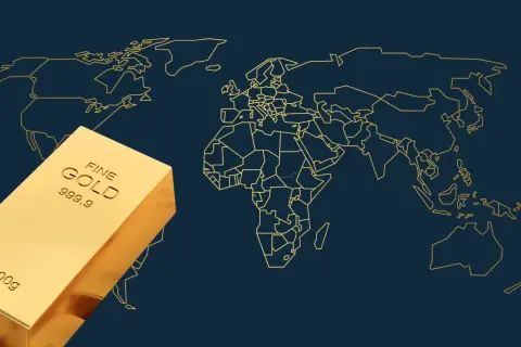 Sztabka złota na tle mapy świata. Obraz symbolizuje globalne zasoby złota i jego znaczenie w światowej gospodarce.