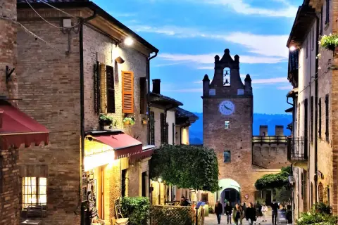 Serata magica a Gradara, Marche. Vicoli illuminati, torre dell'orologio e un'atmosfera incantevole.