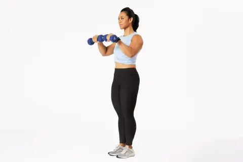 Woman performing dumbbell bicep curls, a key exercise for how to get stronger arms for a girl.