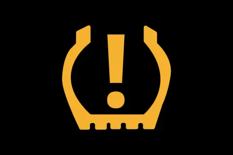 Symbole orange sur fond noir : voyant pression pneu. Attention, un pneu est dégonflé !