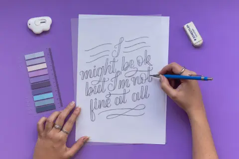 A hand draws "I might be ok but I'm not fine at all" in elegant cursive script.
