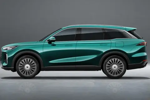 Elegancki, zielony SUV Tiggo 9 prezentuje się nowocześnie na tle szarego studia.