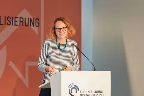Anne Sliwka spricht bei einem Forum zur Digitalisierung. Sie trägt ein gestreiftes Oberteil und eine bunte Kette.
