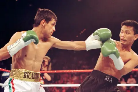 Boxer Ricardo "Finito" Lopez lands a punch in a light flyweight bout.