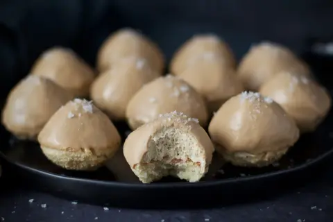 Små, karamellglaserade biskvier med flingsalt, ett läckert biskvier recept. En är uppäten och visar det fluffiga inkråmet.