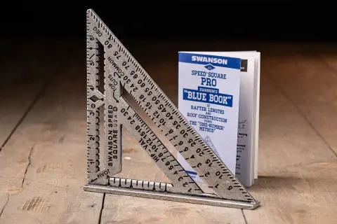 A Swanson Speed Square and its "Blue Book" guide, showing how to use a speed square for roof construction.