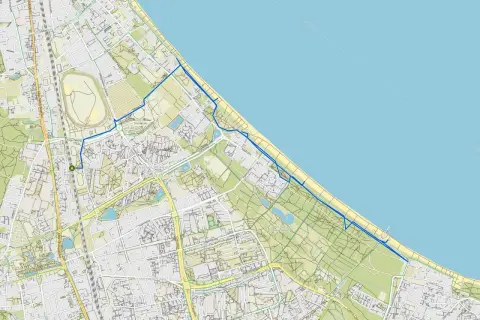 Mapa z zaznaczonymi trasami rowerowymi w Gdyni, biegnącymi wzdłuż wybrzeża i przez tereny zielone.