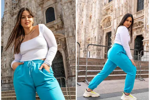 Kobieta plus size, co to znaczy? Pewność siebie w turkusowych dresach przed monumentalną budowlą.