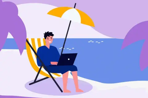 Mężczyzna pracuje na laptopie na plaży pod parasolem. Idealne miejsce na urlop, od kiedy 35 dni urlopu to norma.